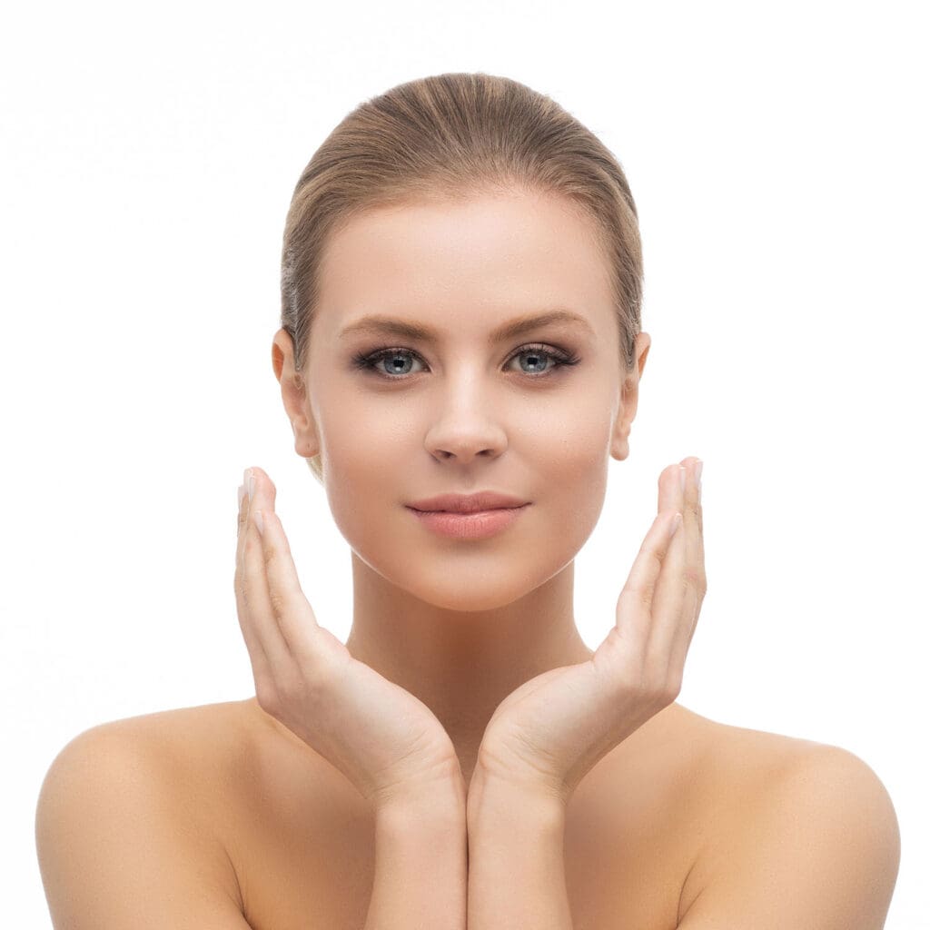 Smiling woman with her hands together cupping her chin