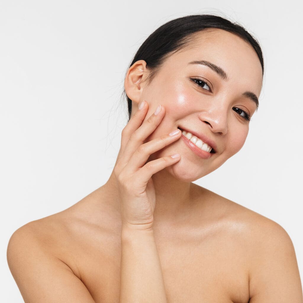 Woman smiling and touching her face