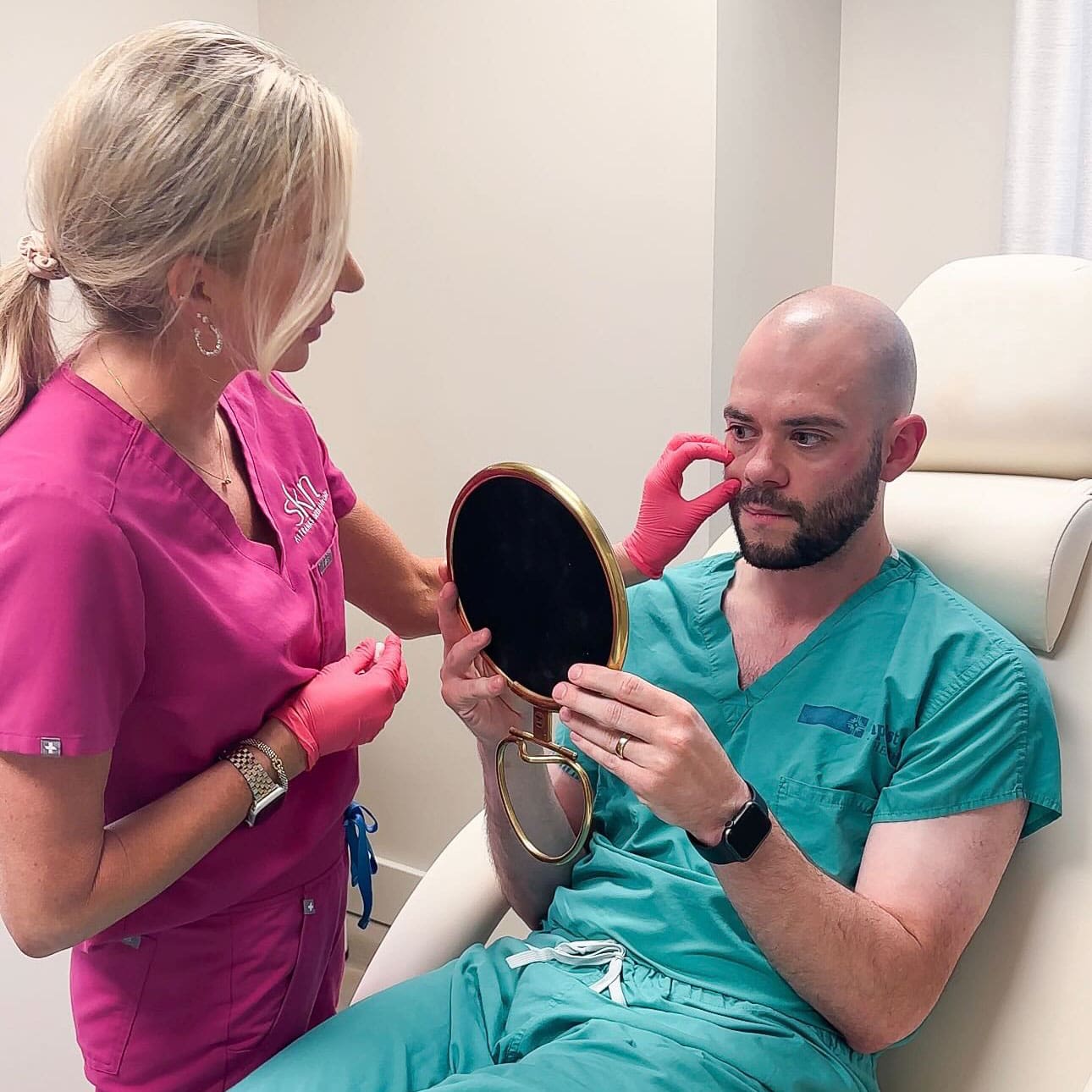 Rachel talking with a male patient as he looks into a mirror